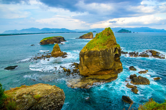 Sea ocean view of giant rocks and wave at papuma beach in jember, east java, indonesia