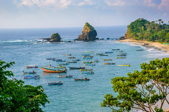 aerial above view with fishermen boats at papuma beach in jember, east java, indonesia