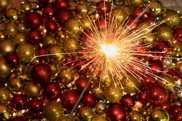 Obraz na płótnie Canvas Close up sparkler firework light up in front of an amazing new year decoration