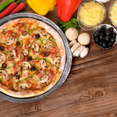 Freshly baked Pizza with ingredients and copyspace