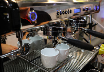  Barista making coffee at coffee machine at Gastrofood - Trade Fair for Food and Drinks for Catering in Cracow. Poland