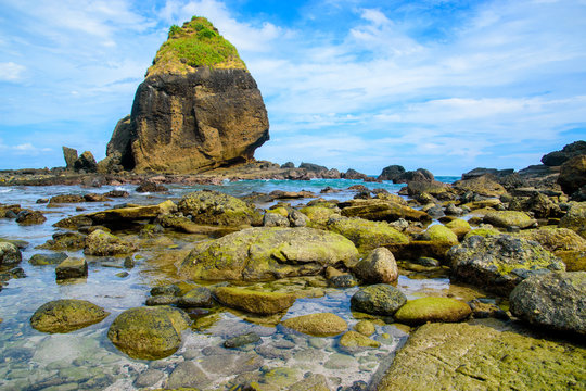 view of huge rocks beach at papuma beach in jember, east java, indonesia