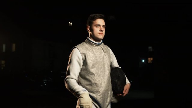 Portrait Of Young Fencer Man Looking Into Camera On The Street.