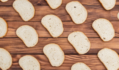 Background of sliced bread on wooden background. Top view.
