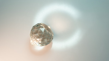Large crystal on a white background with light refraction abstraction. A lot of space for an...