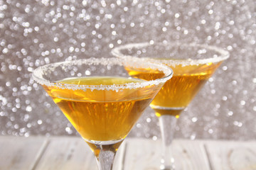 Two glasses with a yellow cocktail