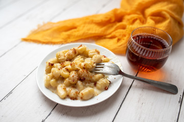 Cheese gnocchi with cheese sauce and bacon bits for garnish on top