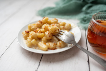 Cheese gnocchi with cheese sauce and bacon bits for garnish on top