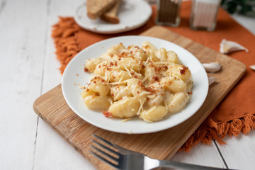 Cheese gnocchi with cheese sauce and bacon bits for garnish on top