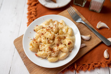 Cheese gnocchi with cheese sauce and bacon bits for garnish on top