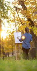 young woman artist drawing a picture on canvas on an easel in nature, a girl with a brush and a palette of paints working inspired by early autumn, a concept of art, hobby