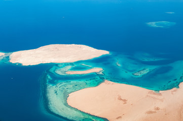 High above view of coral reefs and sandy islands in Red sea, Egypt (soft focus)