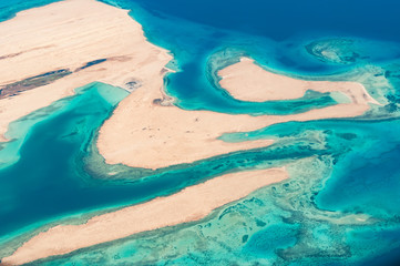 High above view of coral reefs and sandy islands in Red sea (soft focus)