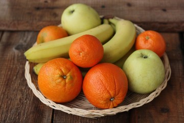 Naklejka na ściany i meble Oranges apples and bananas on the table 