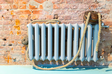 Old cast iron radiator and tow rope.