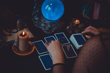 Magical scene, esoteric concept, fortune telling, tarot cards on a table 