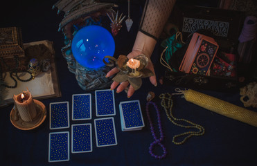 Magical scene, esoteric concept, fortune telling, tarot cards on a table 