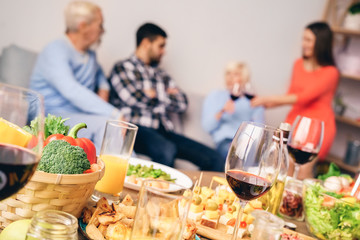 Group of people sitting at home after dinner