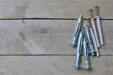 dowels and anchors on a weaved background. flat lay, place for text.