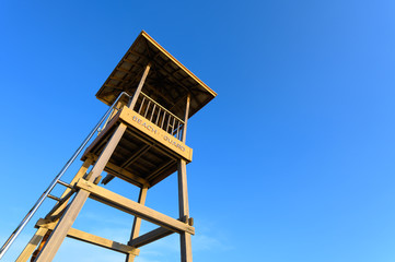 Life guard tower or station against blue sky
