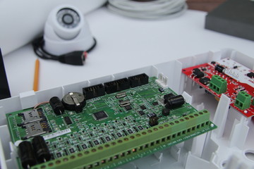 CCTV camera on the table with drawings and equipment for building a security system