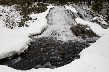 Fototapeta na wymiar East Duchesnay Falls and River after a Spring snowfall in North Bay