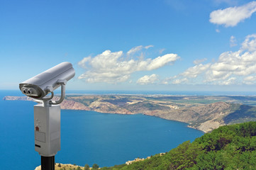 Coin-operated binoculars looking out over Moutains