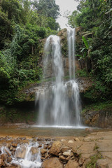 Fototapeta na wymiar Amazing waterfall in the jungle of Vietnam near the town of Baalok. Flowing water effect.