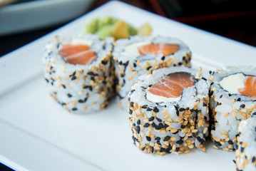 Uramaki Philadelphia Salmon and Cream Cheese	on a white plate, asian food, japanese cuisine