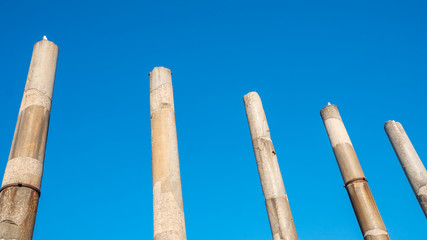 antique columns against the blue sky, the historical part of the city of Rome.