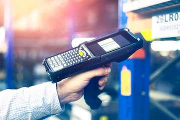 Modern warehouse management. Supervisor hold hand terminal/barcode scanner for logistics. © davidjancik