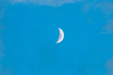 young moon on light blue sky, quarter moon. - obrazy, fototapety, plakaty