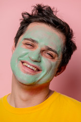beautiful brunette man with algae mask on his face