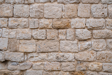 Gray old stone wall background. yellow rock wall made of stone.