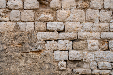 Gray old stone wall background. yellow rock wall made of stone.