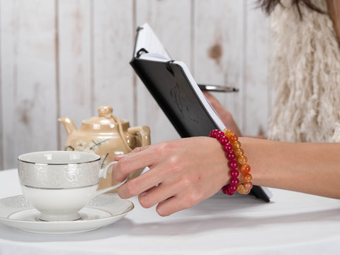 Woman hand coffee with bracelet