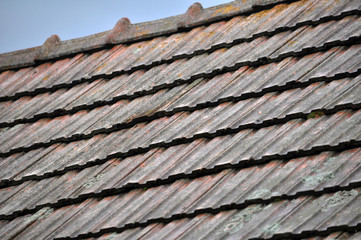 On the roof of the house is an old red tile