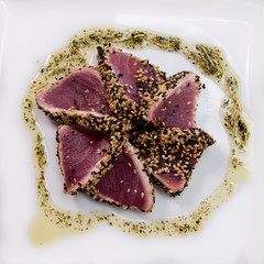 sesame tuna sashimi with soy sauce, raw tuna flower with pesto sauce, top view, japanese food, asian food, japanese cuisine