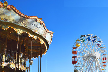 Carousel and Ferris wheel against the sky