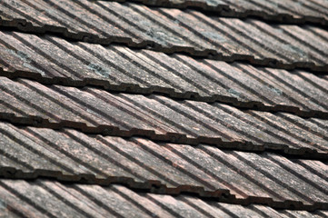 On the roof of the house is an old red tile