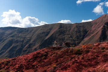 A panoramic view of Mount Kazbegi is a sleeping stratovolcano and one of the main mountains of the Caucasus, located on the border of the Kazbegi region of Georgia. In lush lava color. Design and crea