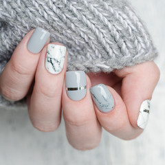 white grey marble manicure with silver stripe on grey background