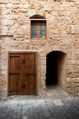 Fototapeta na wymiar Limestone wall with doors and windows in ancient city Saida, Lebanon