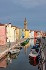 Fototapeta na wymiar Colorful Buildings Line a Canal in Burano Italy
