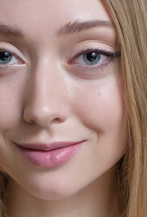 Beauty portrait, blue-eyed blonde with make-up.