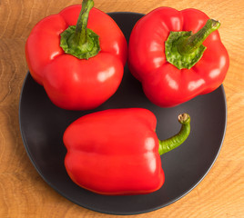 Red pepper in a plate on a wooden board