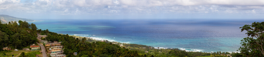 Beautiful Panoramic View of the Caribbean Sea from top of a hill during a sunny and cloudy day....