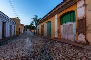 Trinidad, Cuba. Street view of a Residential neighborhood in a small Cuban Town during a cloudy and sunny sunrise.