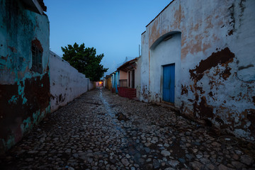 Trinidad, Cuba. Street view of a Residential neighborhood in a small Cuban Town during a cloudy and sunny sunrise.