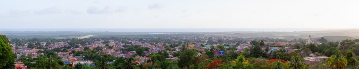 Aerial Panoramic view of a small touristic Cuban Town during a colorful and cloudy sunset. Taken in Trinidad, Cuba.